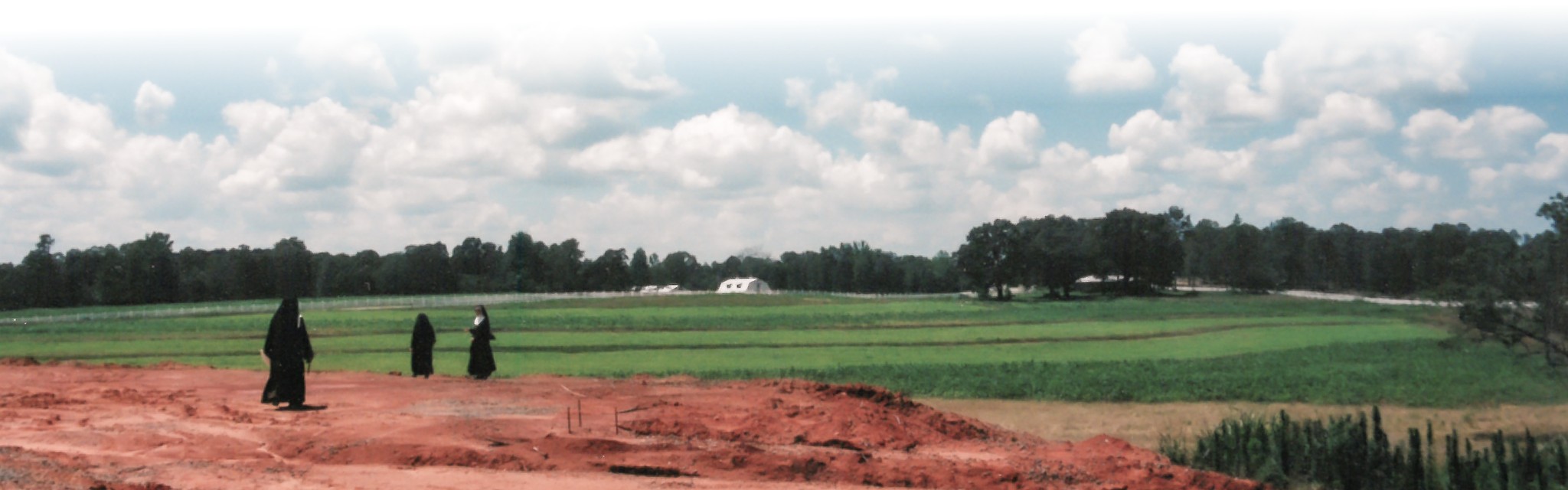 Nuns walking in open field before Shrine construction began